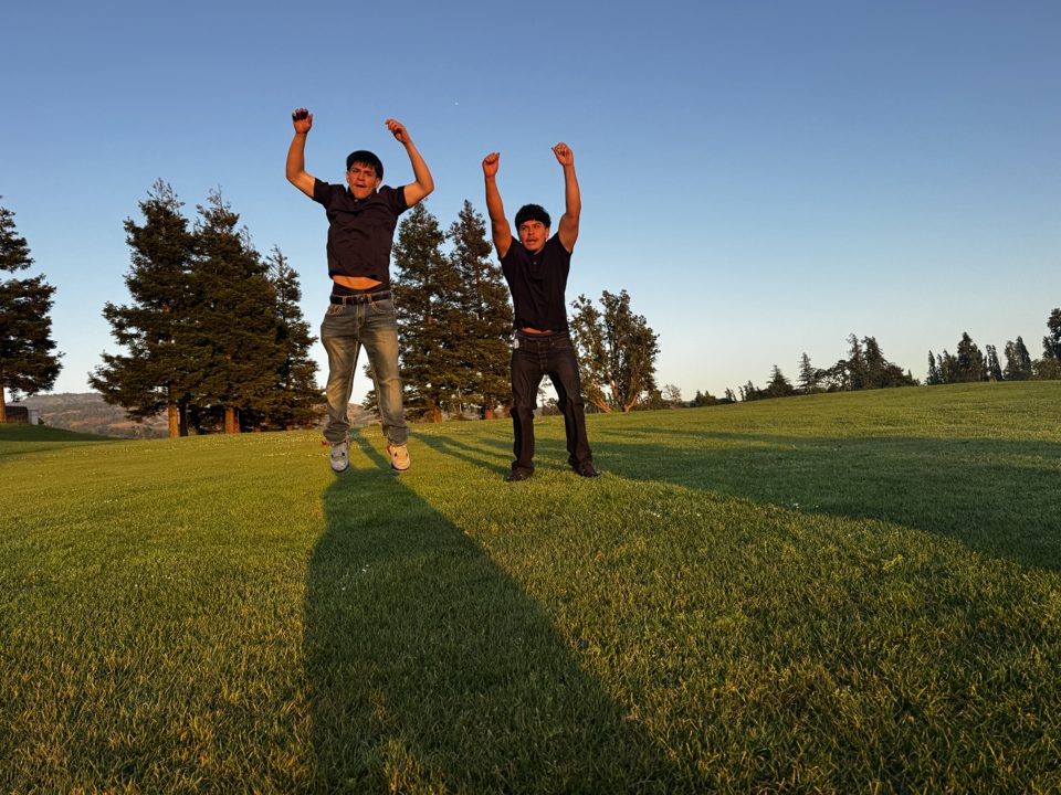 Two young people leaping with joy — the future Legacy Rising is building